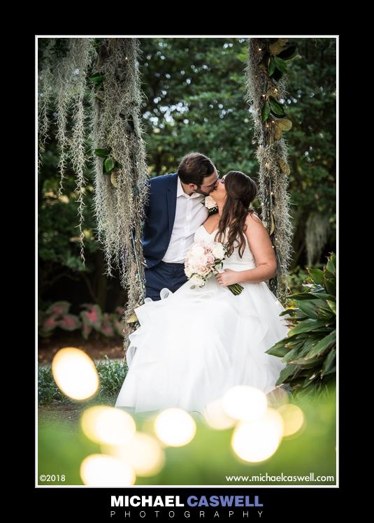 Bride and groom on swing at Southern Oaks