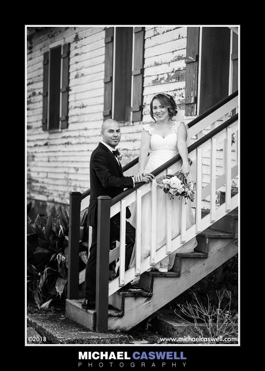 Bride and groom black and white portrait by old building